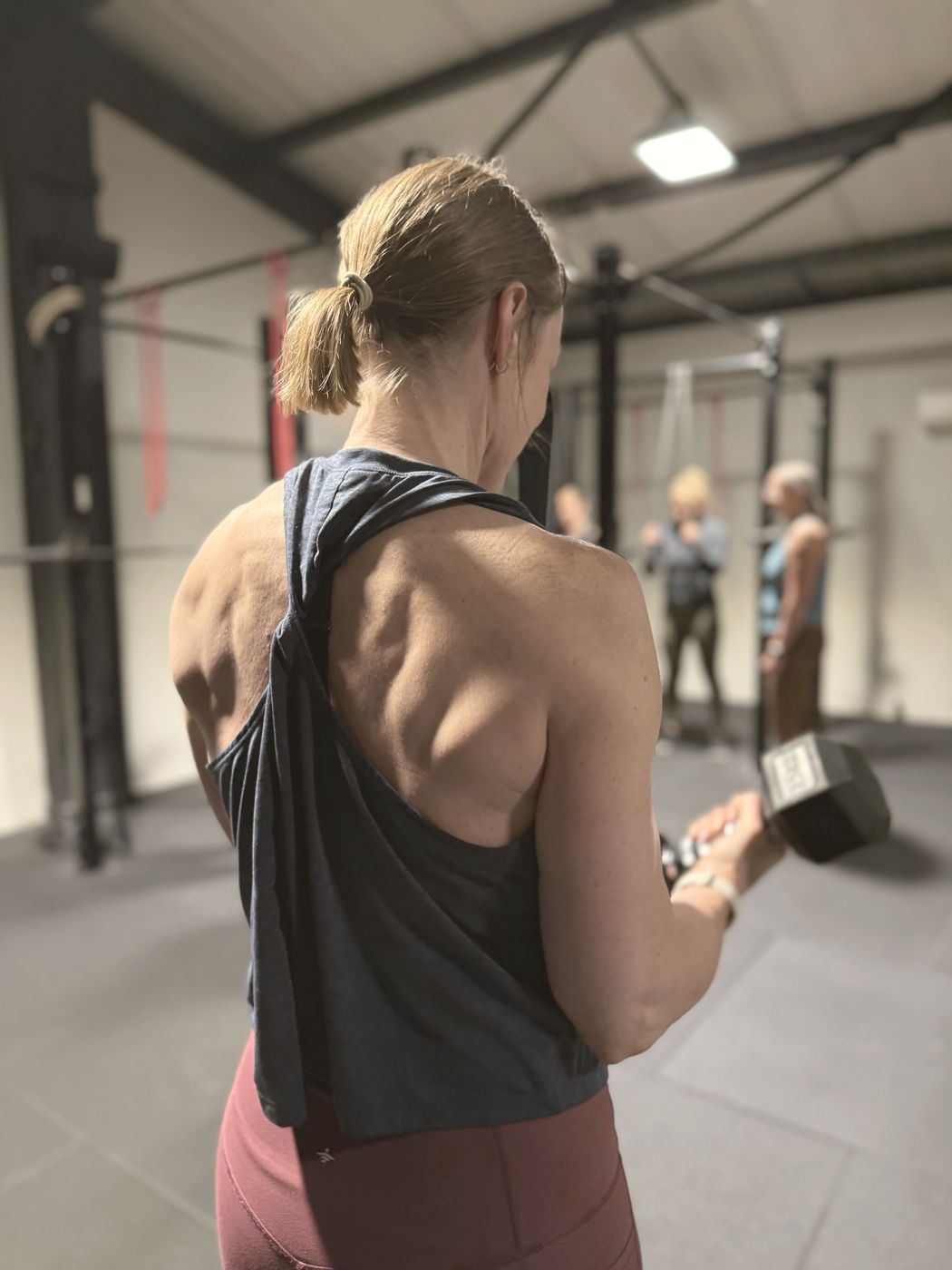 A member doing a dumbbell curl in the studio