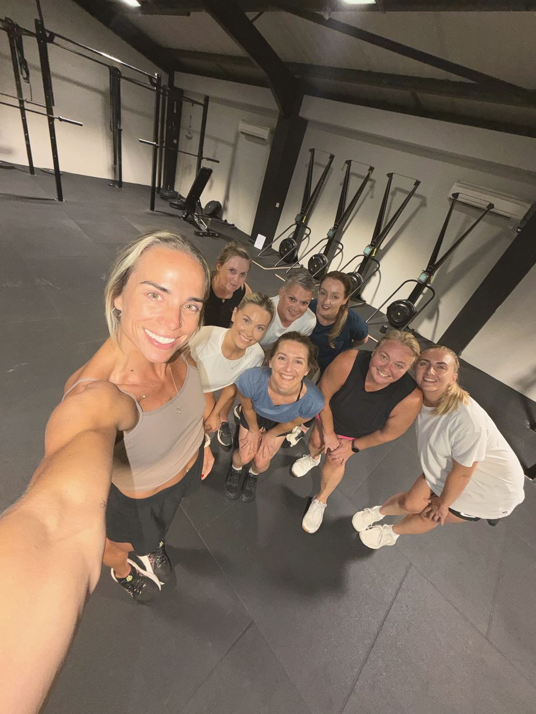A member taking a group selfie with women from her session